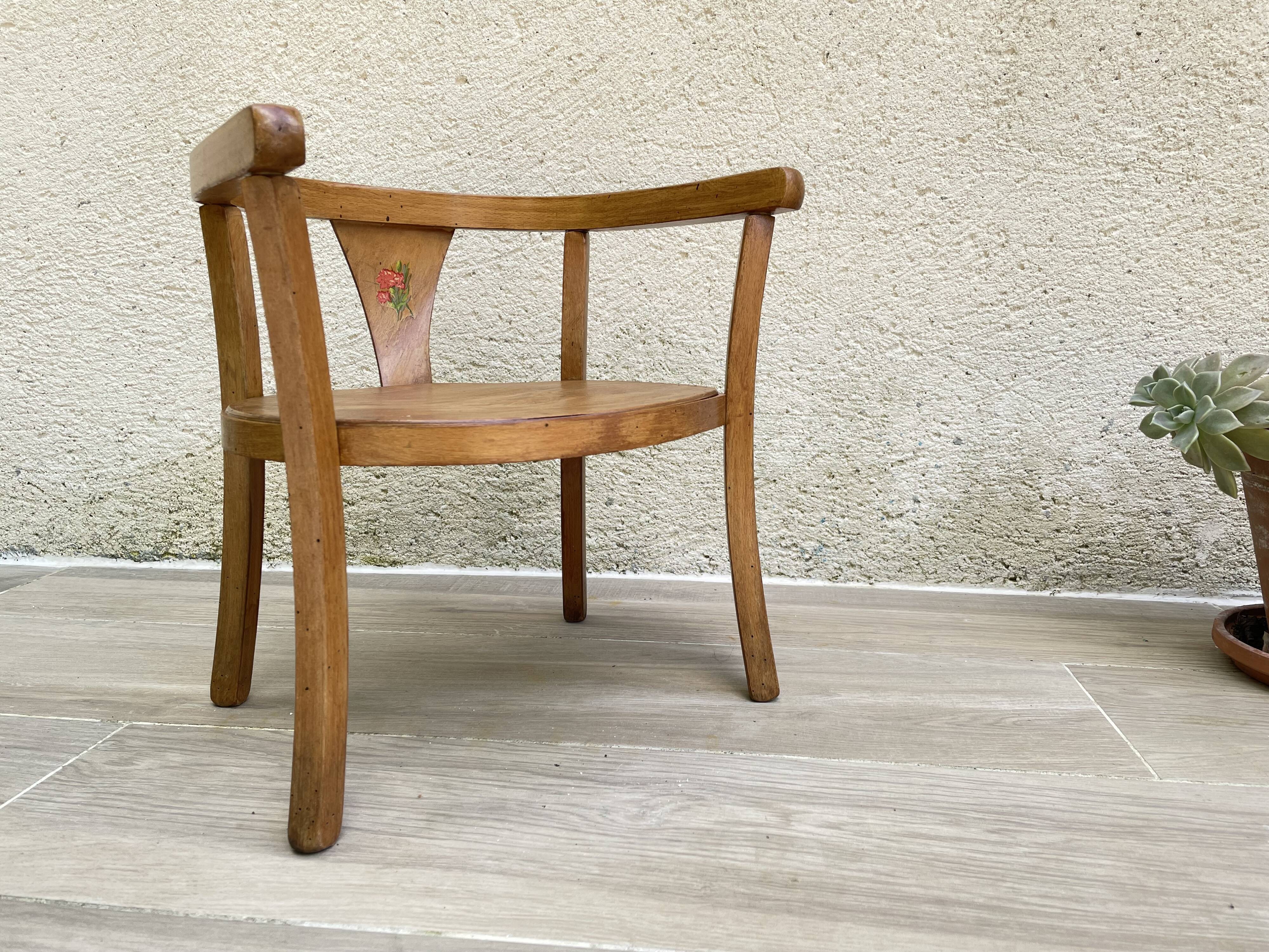 Old armchair for children in wood