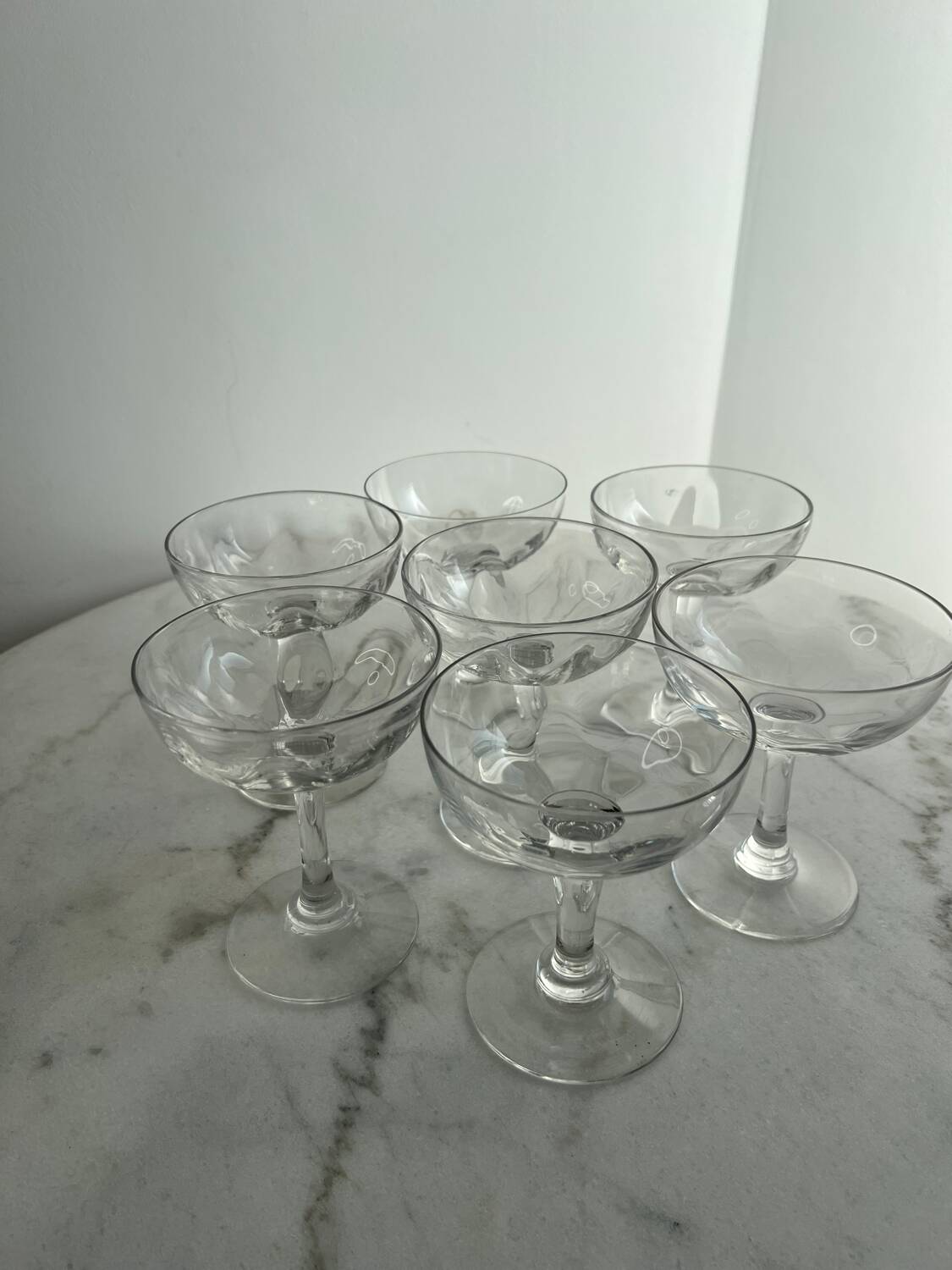 Set of seven blown glass stemmed glasses.