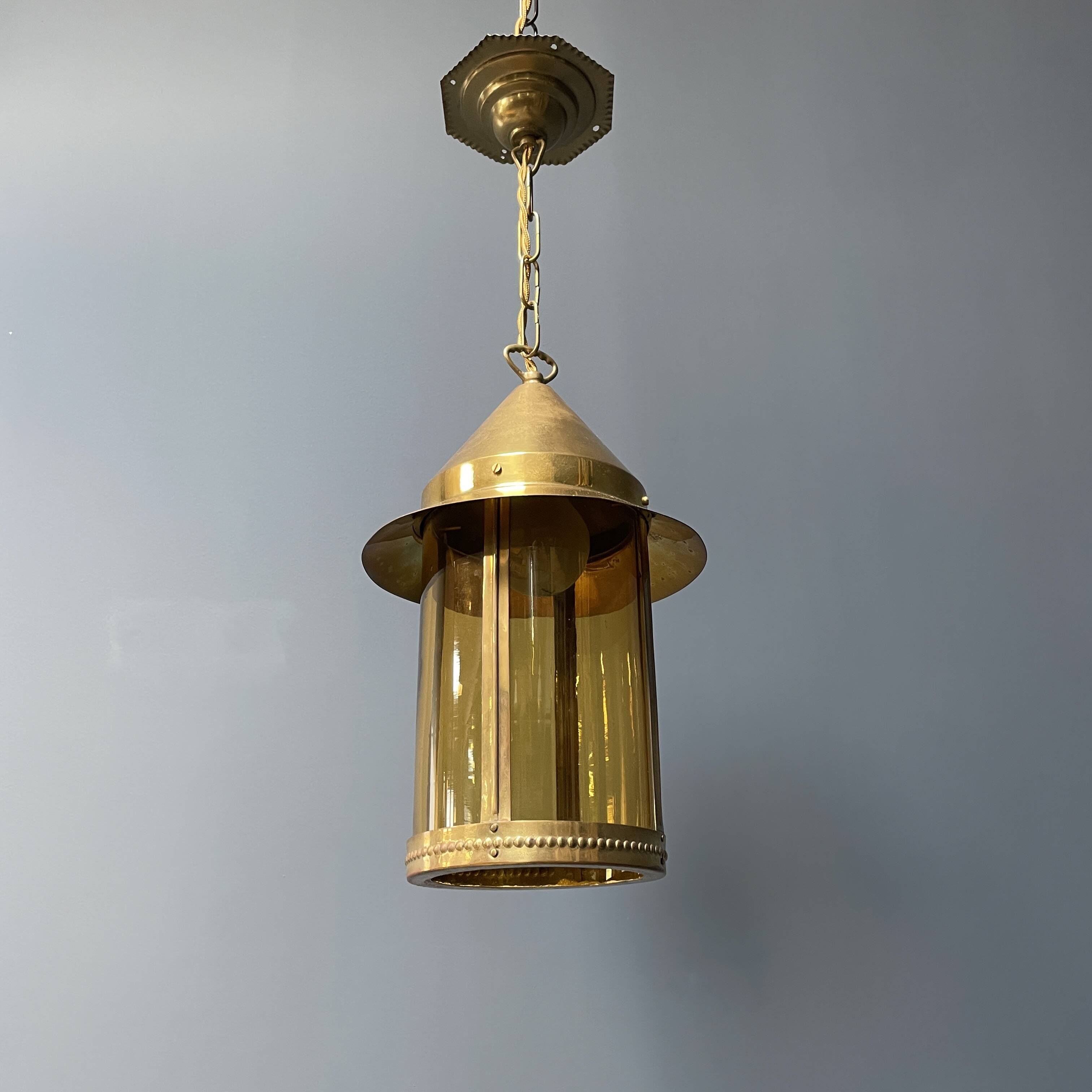 Brass lantern pendant lamp with yellow glass
