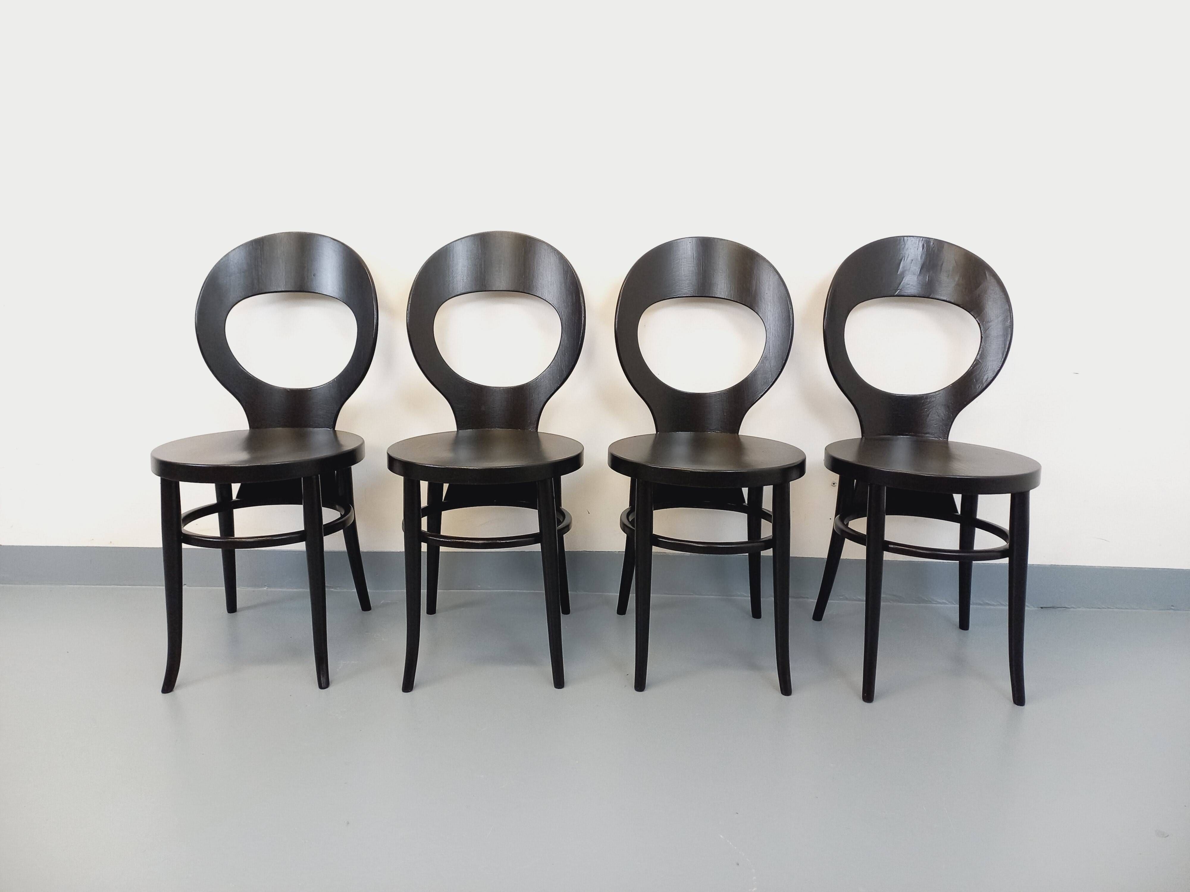 Set of 4 vintage Mouette chairs by Baumann in black wood from the 1960s.