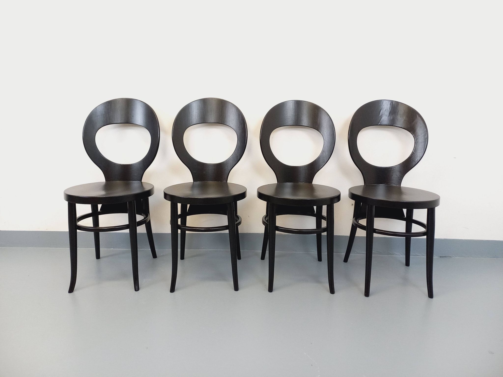 Set of 4 vintage Mouette chairs by Baumann in black wood from the 1960s.