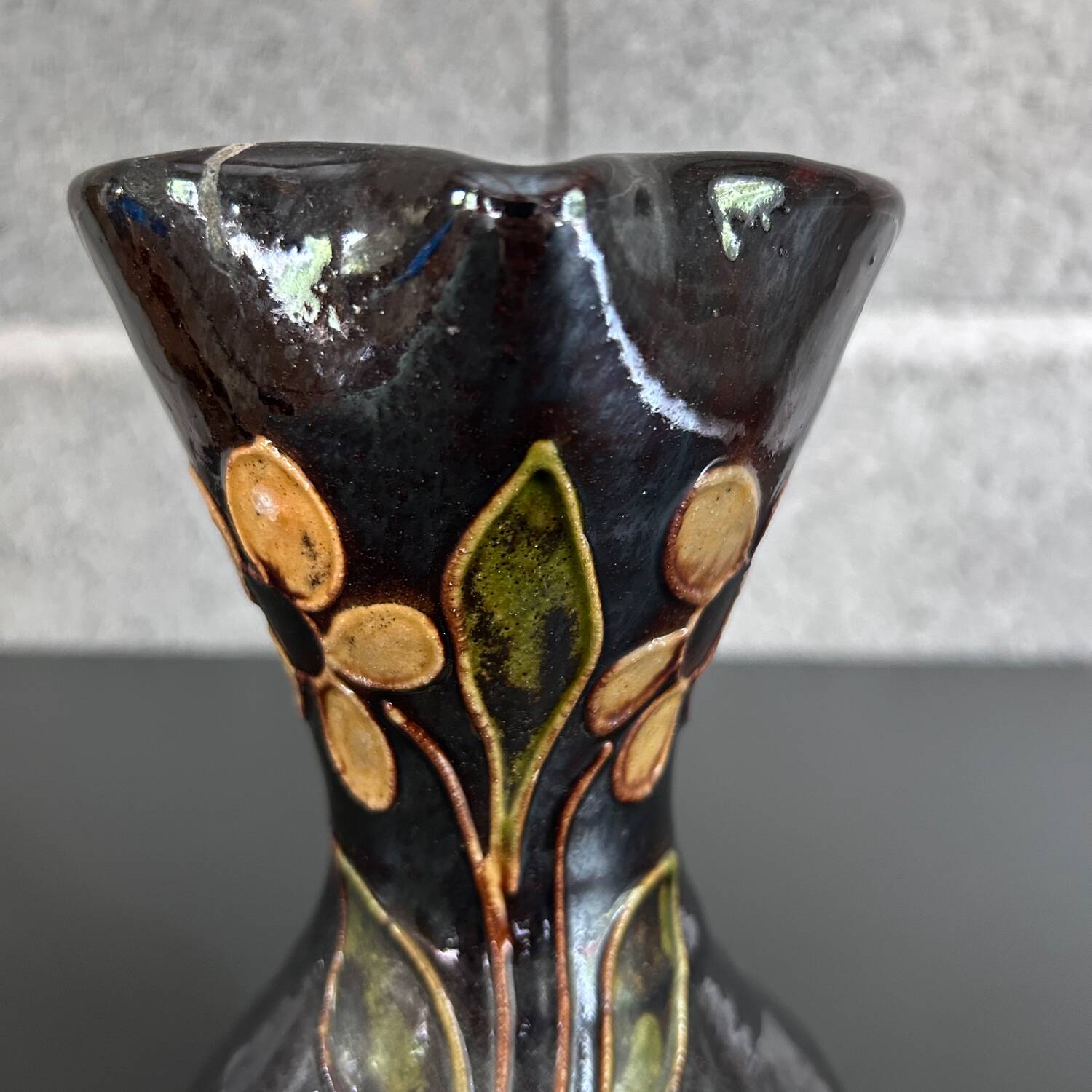 Black vase with yellow flowers