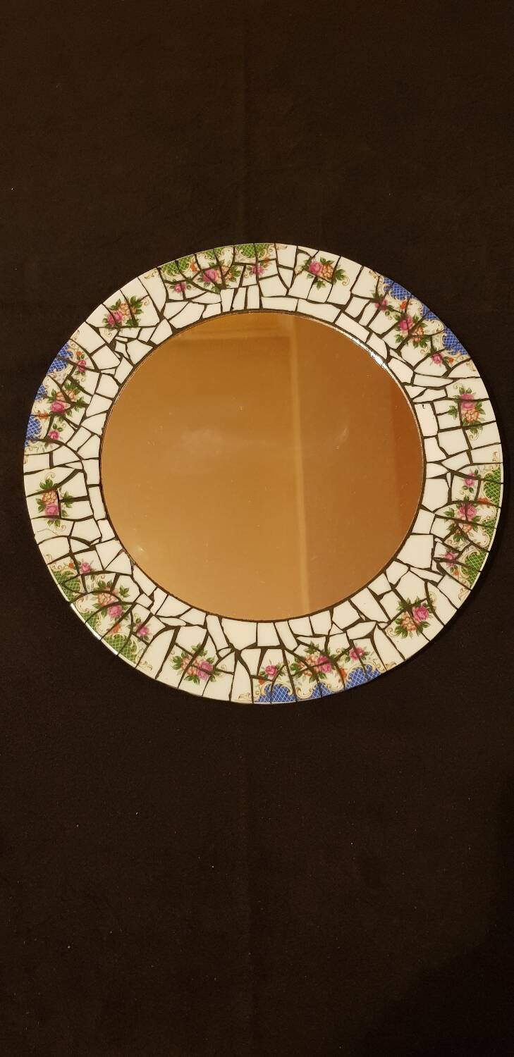 Ceramic mirror. Floral decor.