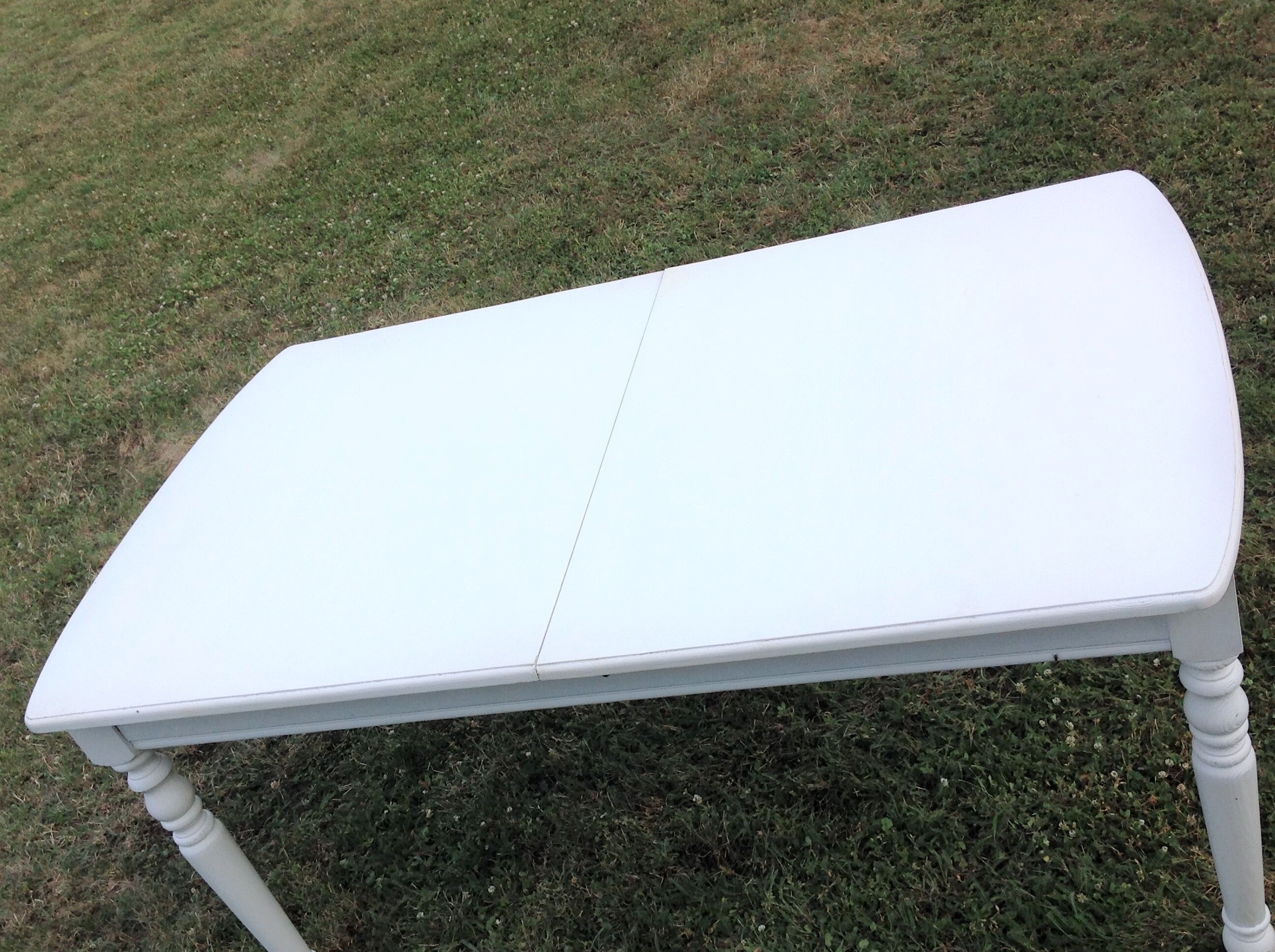 White farmhouse table set and four chairs