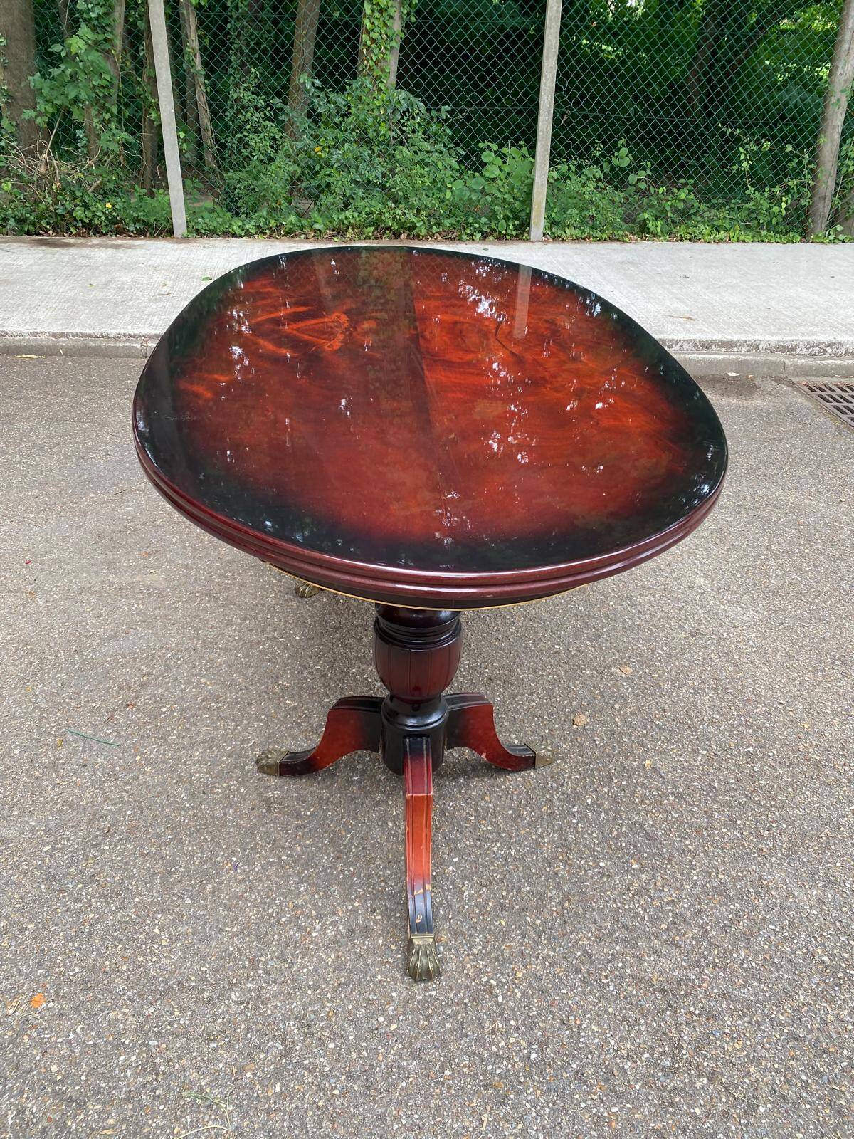 Glossy mahogany dining table in English Regency style from the 1970s.