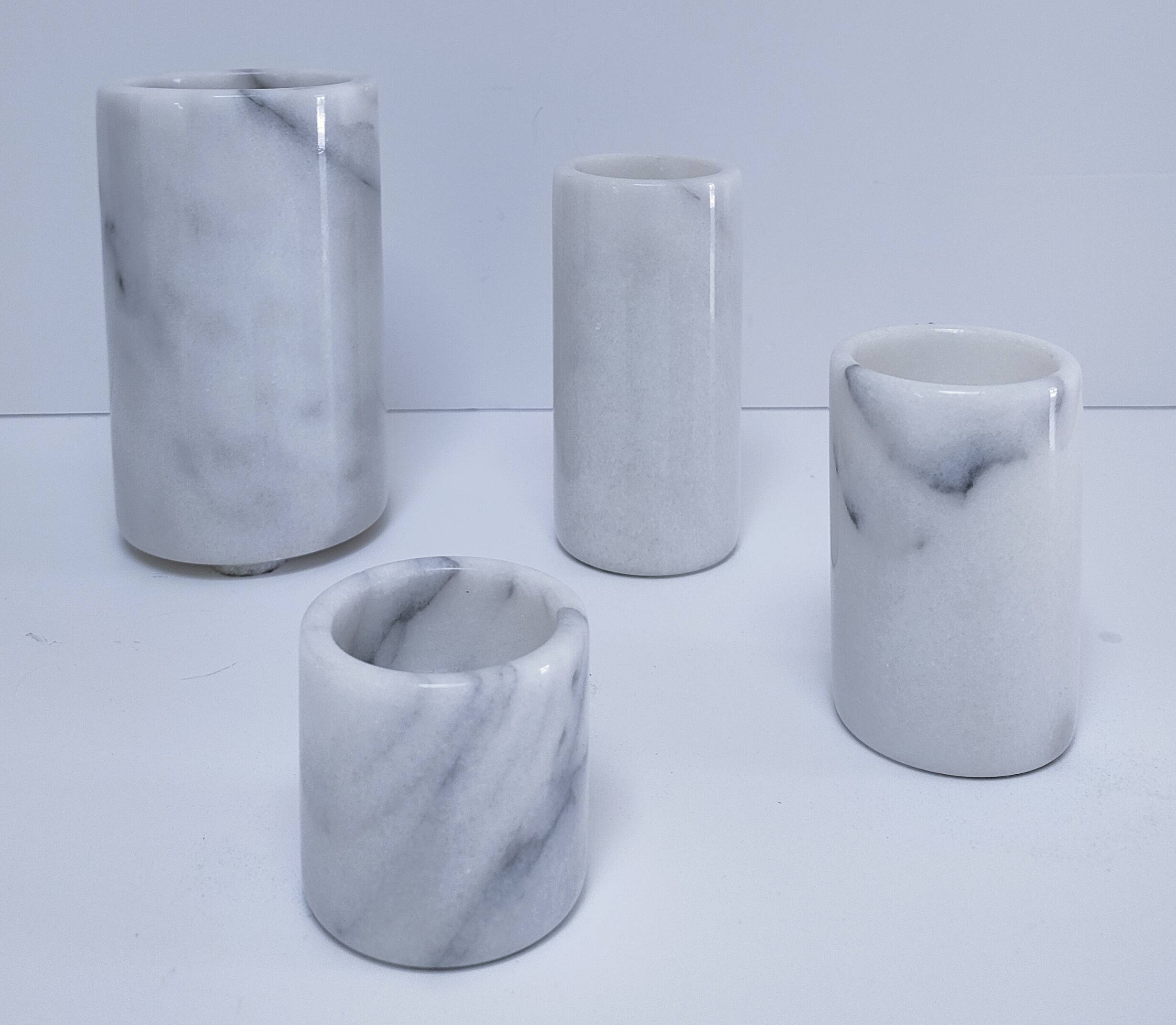 Four white marble candlesticks with black veins, 70s design