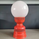 Vintage globe lamp with a metal base, perforated and lacquered in red.