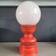 Vintage globe lamp with a metal base, perforated and lacquered in red.
