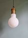 Large bulbous pendant light in white opaline and brass