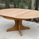 Round extendable Scandinavian dining table in Baumann style oak with central leg