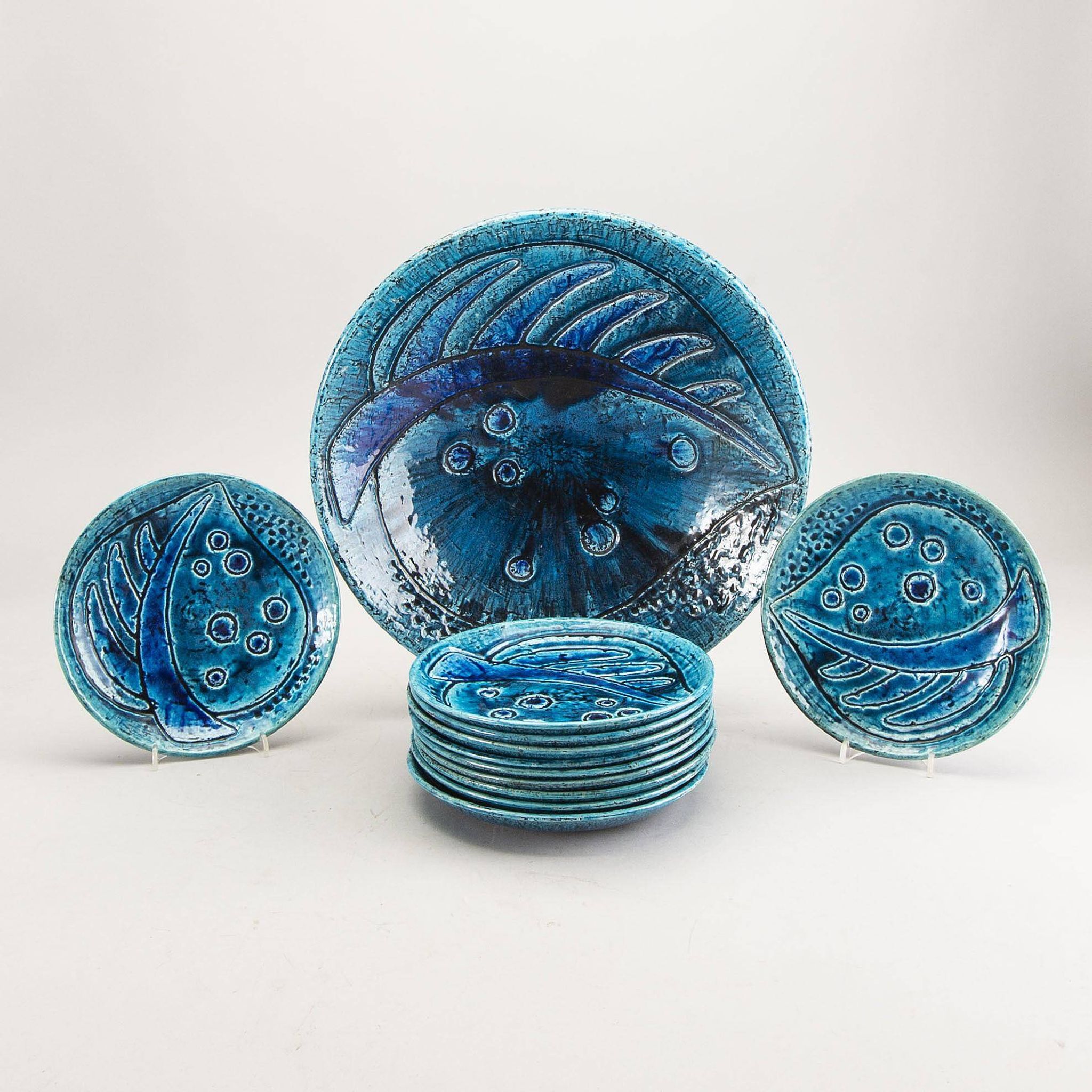 A stoneware bowl and 11 plates by Charlotte Hamilton, Sweden, 1970, Signed
