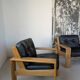 Pair of raw oak and leather armchairs by Esko Pajamies for Asko, Finland.