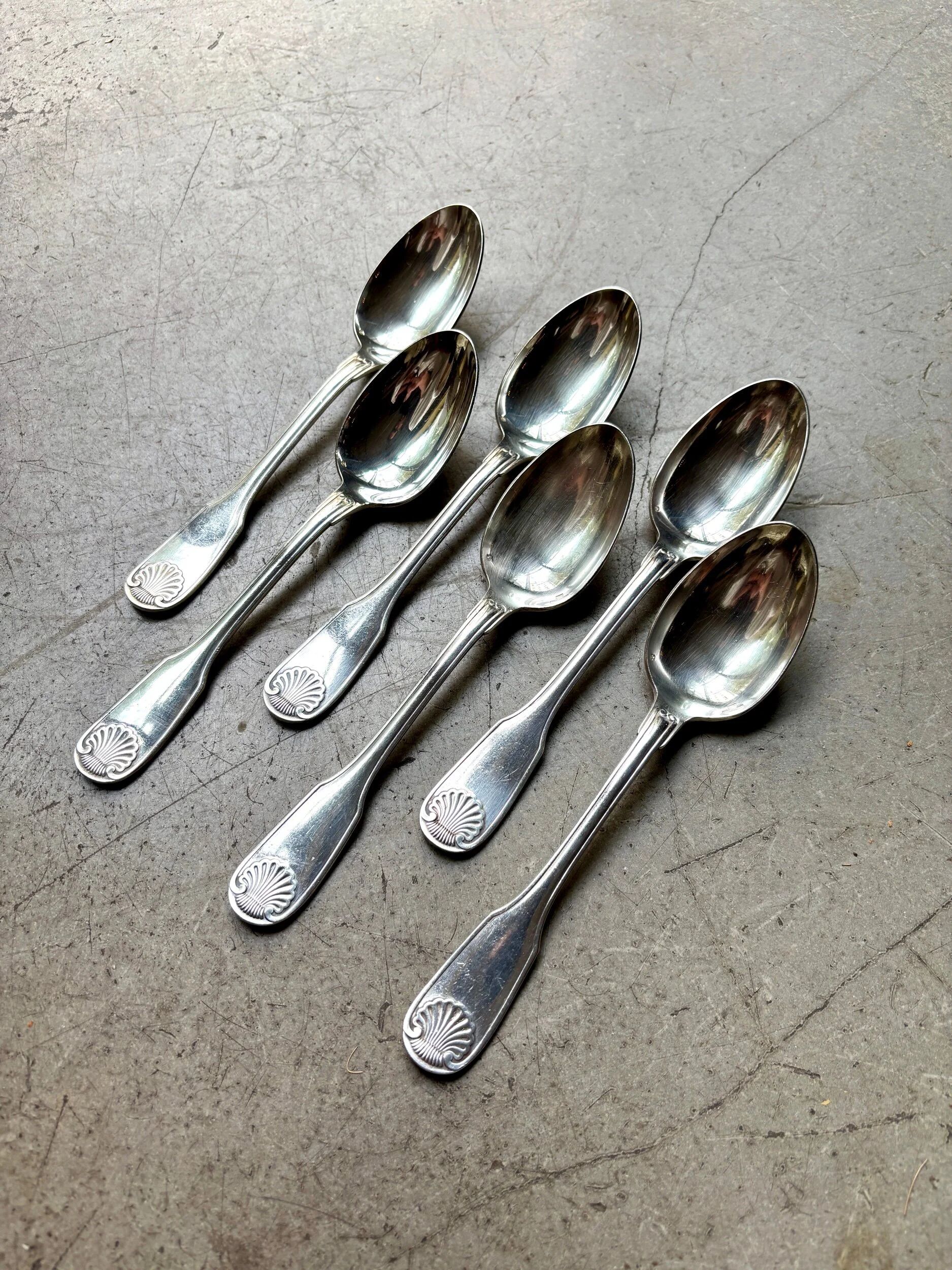6 large Christofle silver-plated spoons with shell decoration.