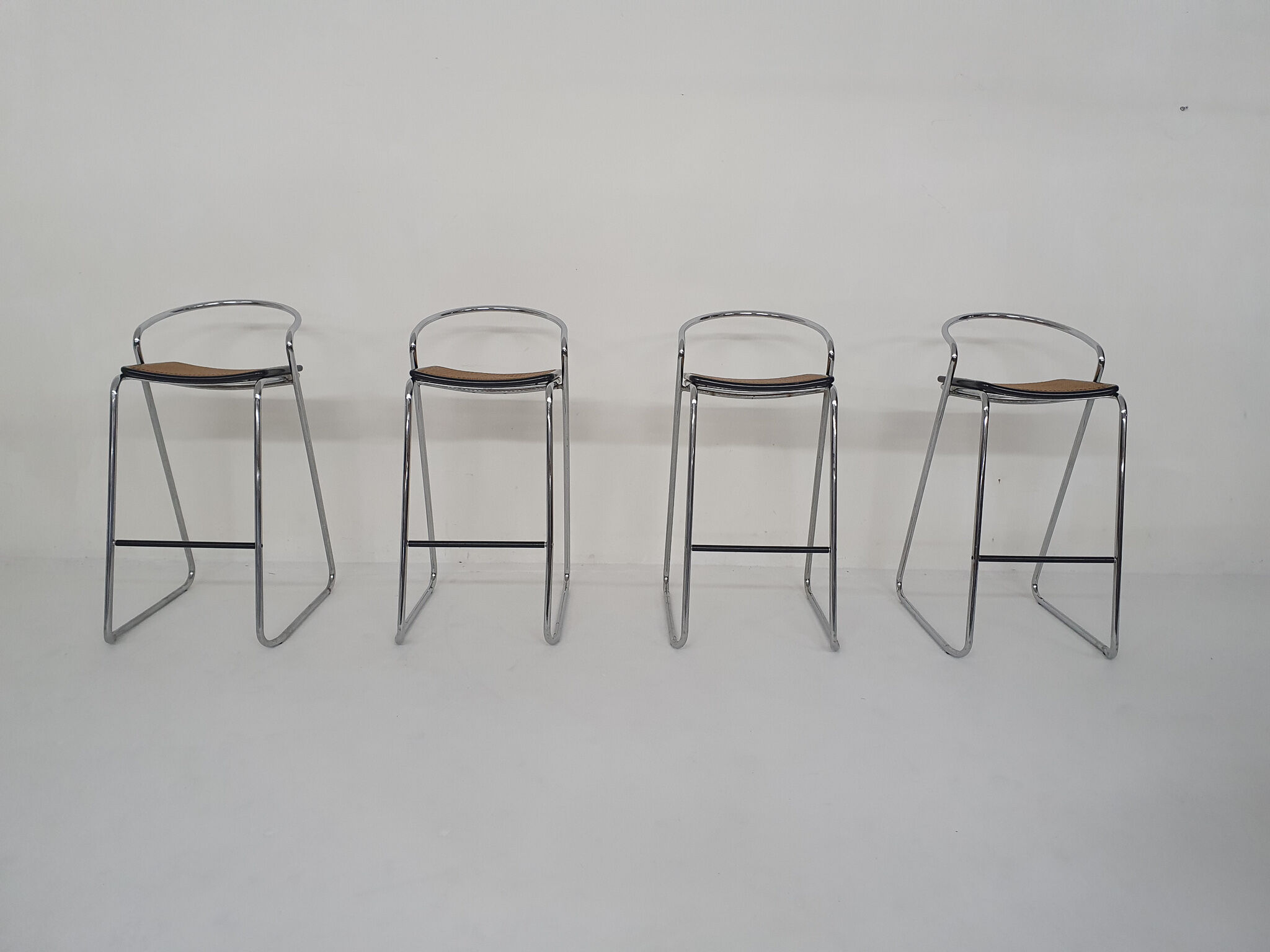Set of four chrome and cane bar stools, 1970's