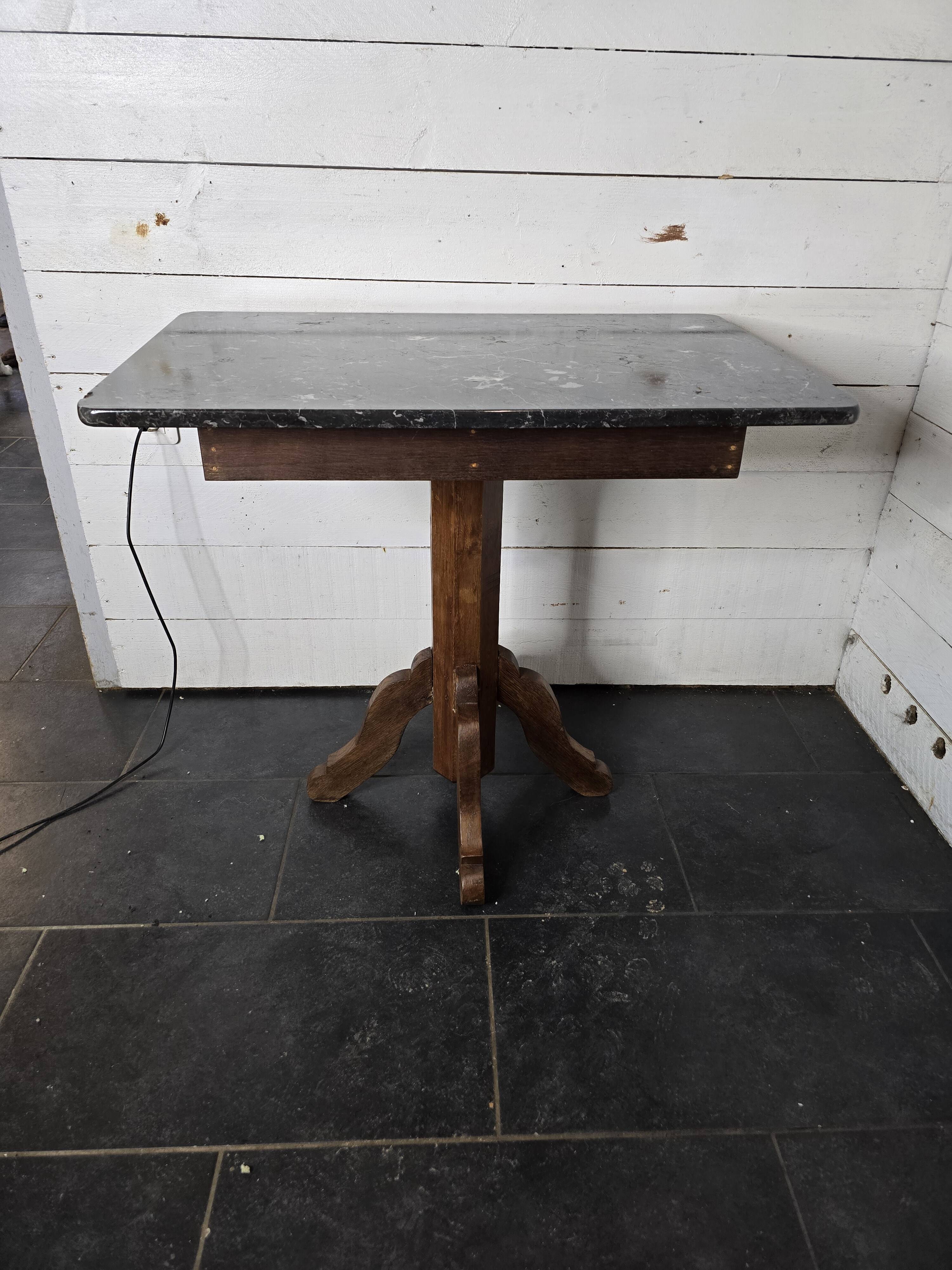 Old pedestal table with oak legs and marble top