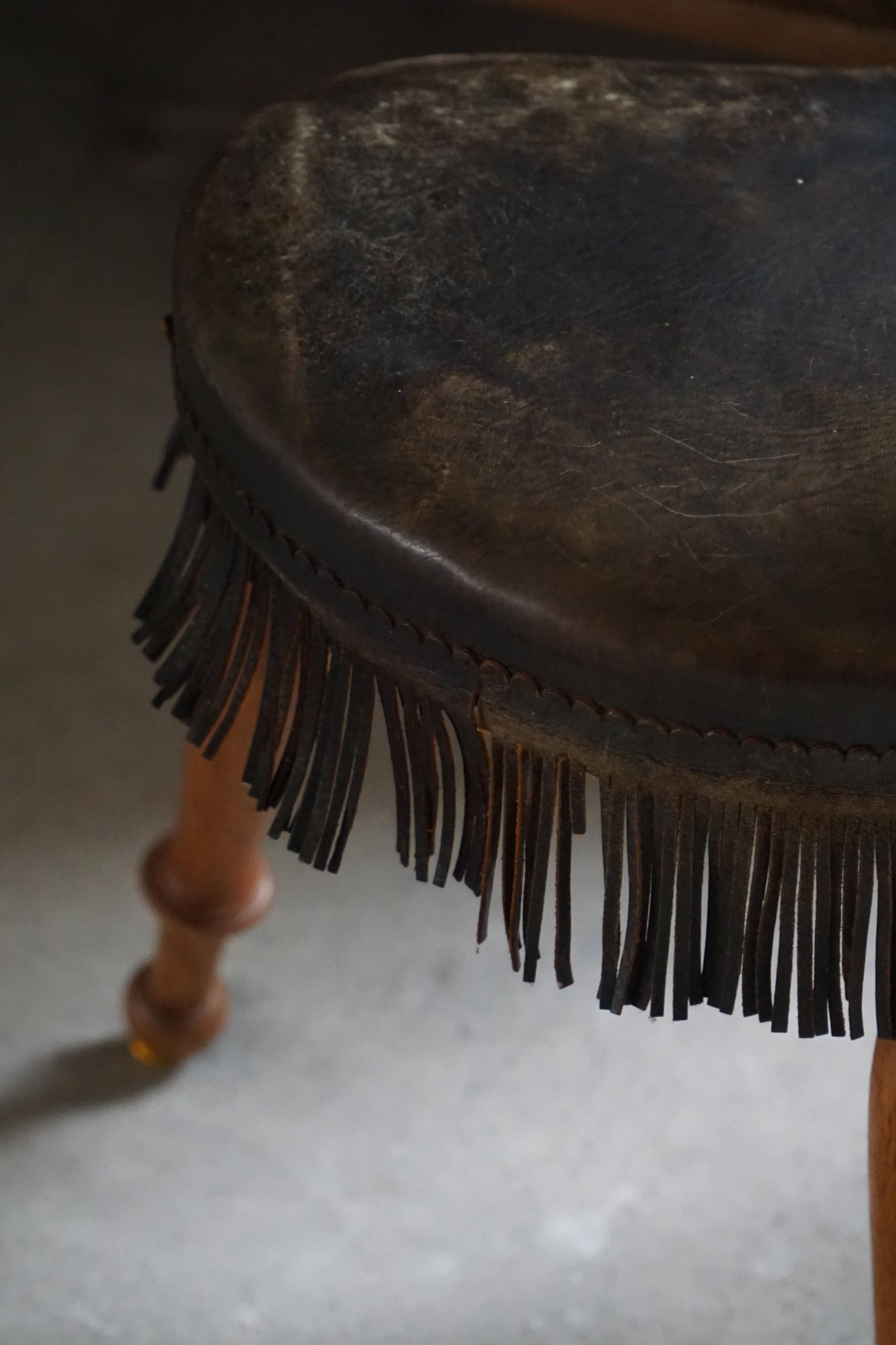 Danish oak tripod stool from the early 20th century with leather fringe, 1930s.