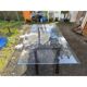 Vintage table with a glass top and smoked plastic trestle legs.