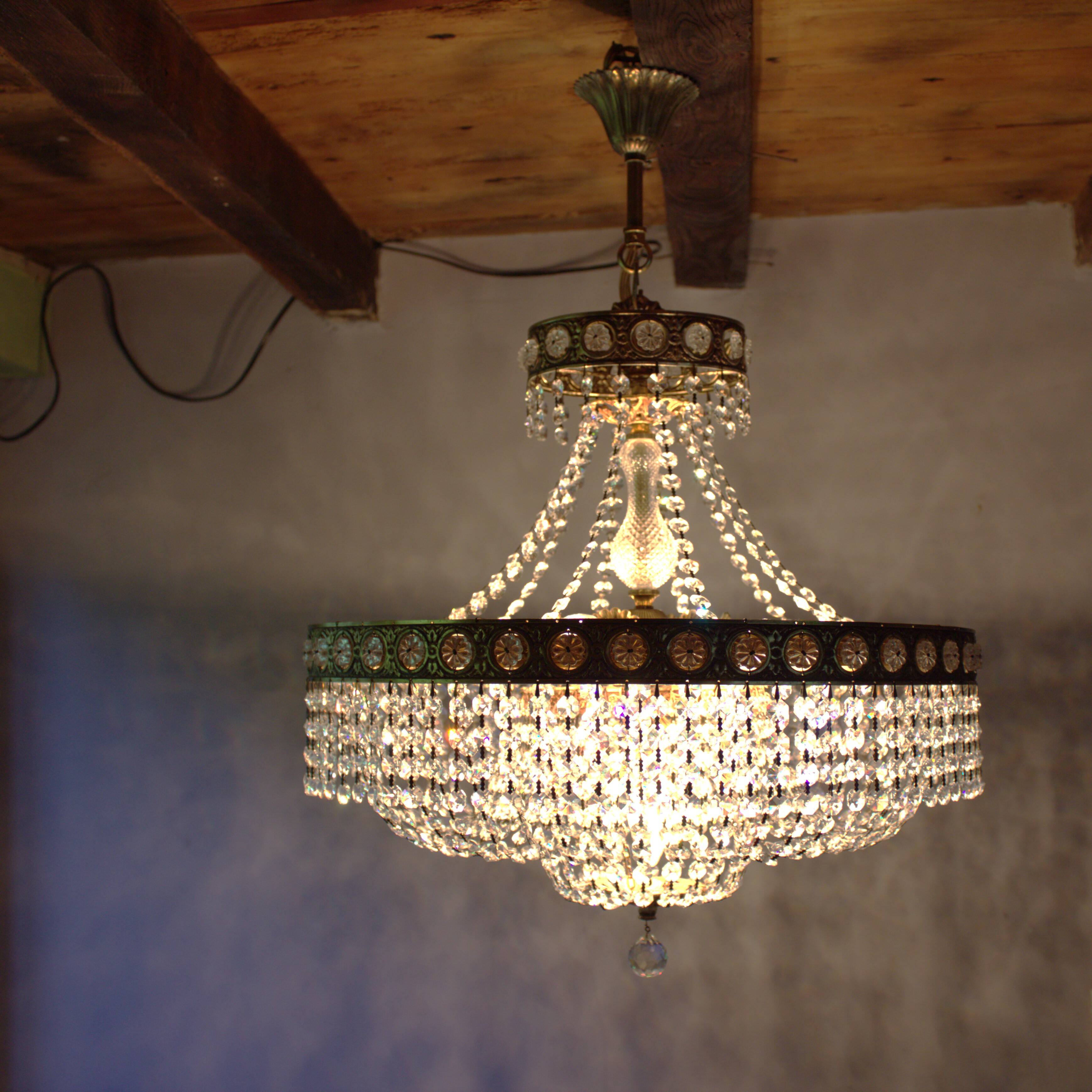 Antique castle style chandelier with tassels and floral details