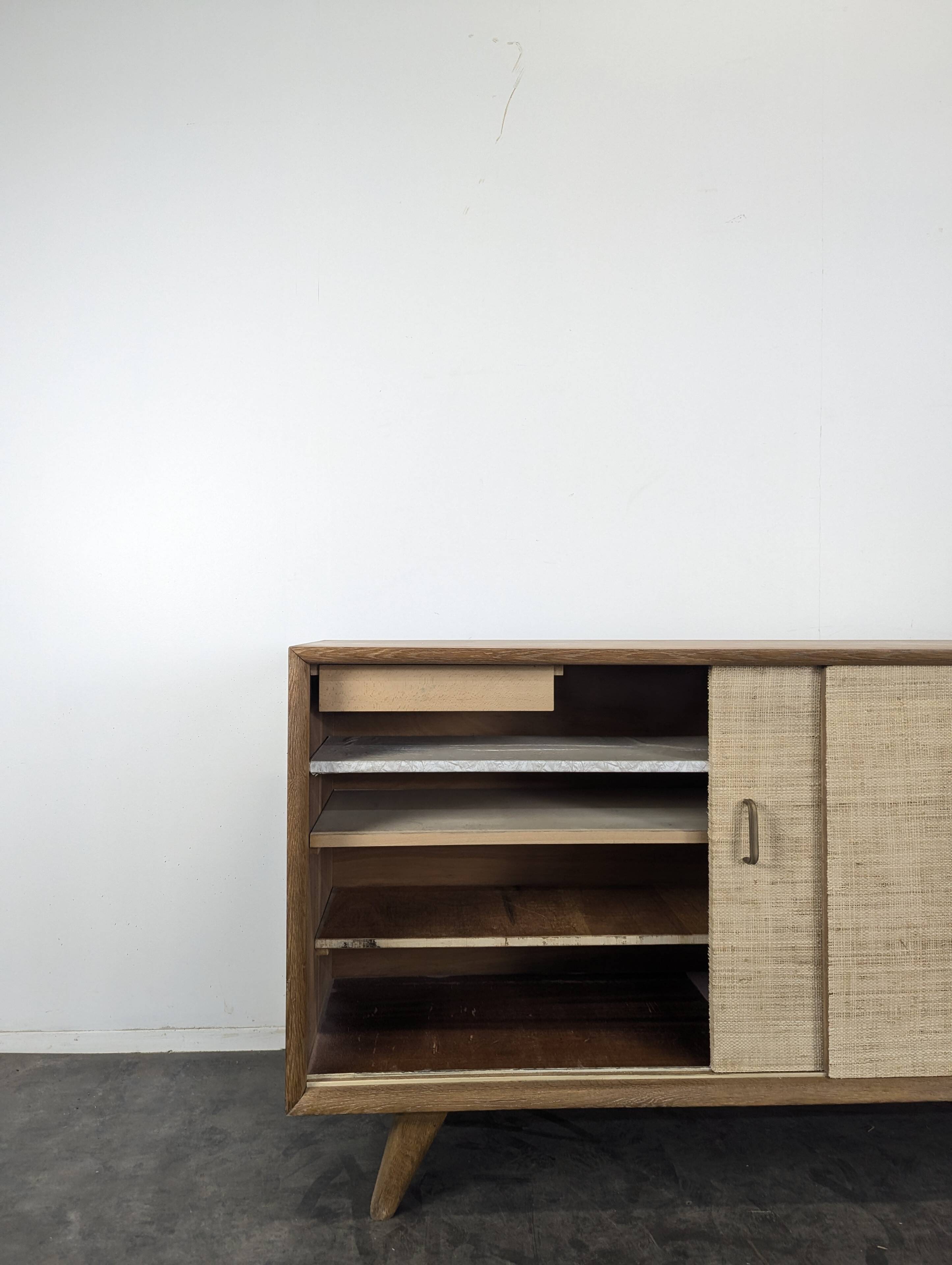 Modernist sideboard in oak with rattan doors.