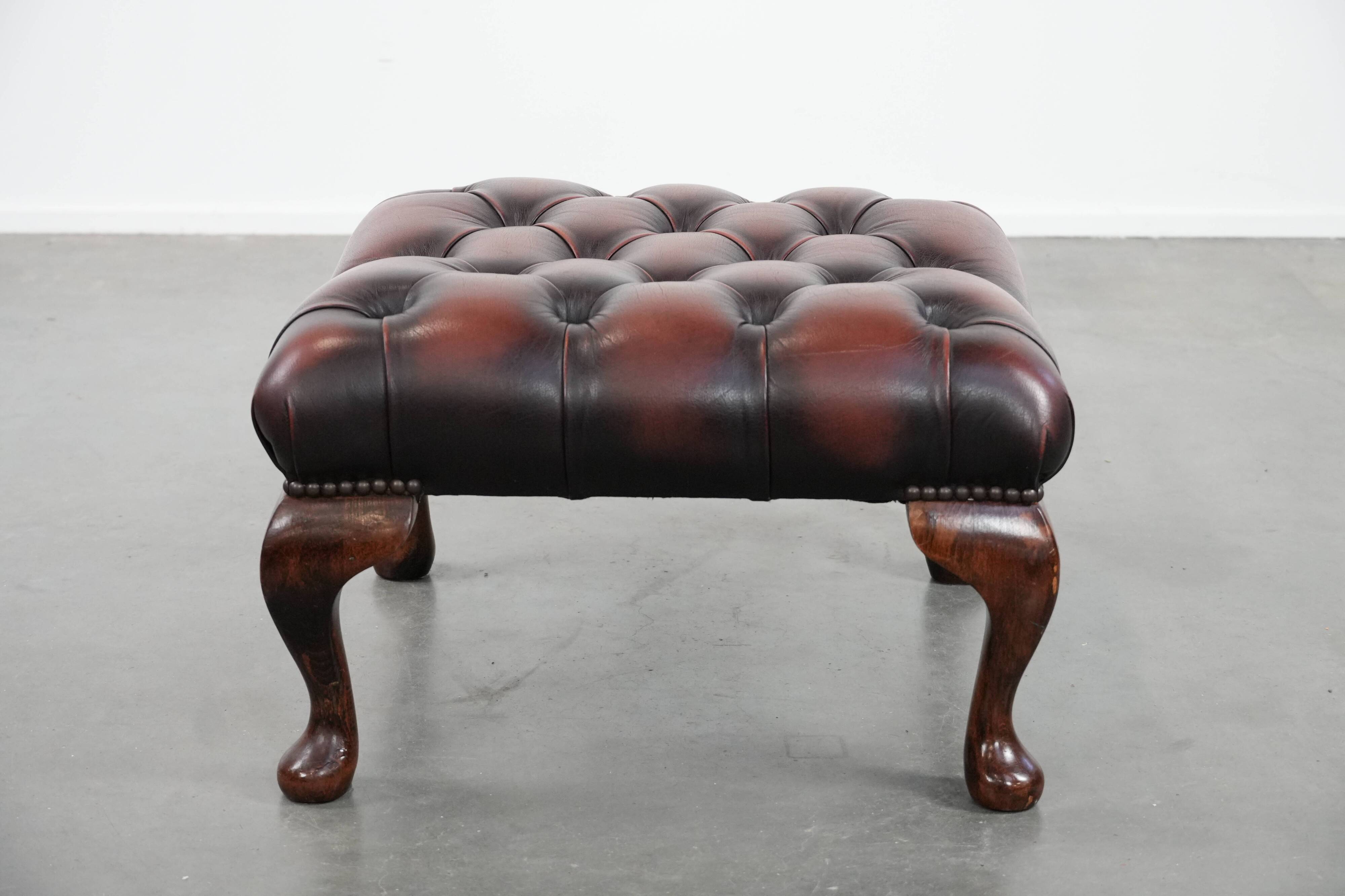 Dark brown chesterfield ottoman in cowhide leather