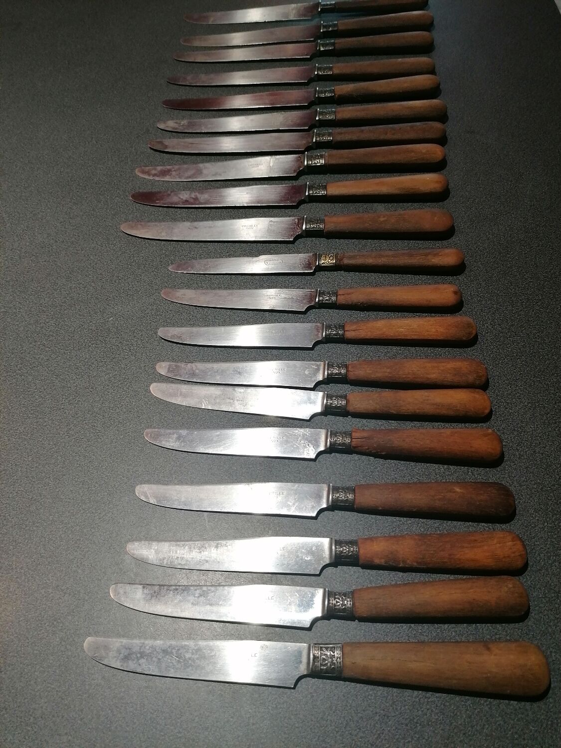 Old table knives and dessert knives, wooden handles, stainless steel blades