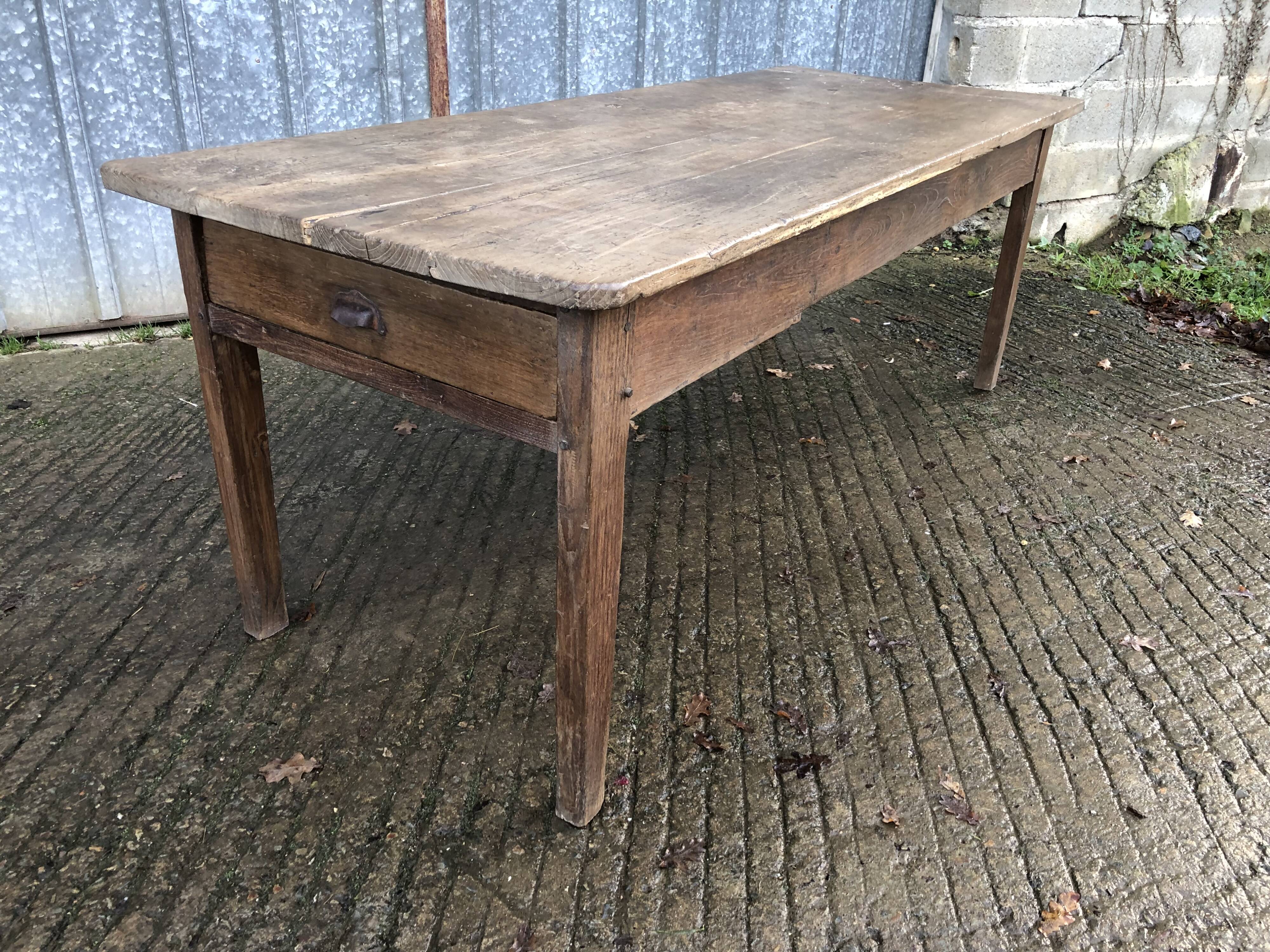 Antique farmhouse table in solid oak with tapered legs and 1 drawer at the end.