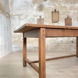Solid wood workshop table with straight legs.