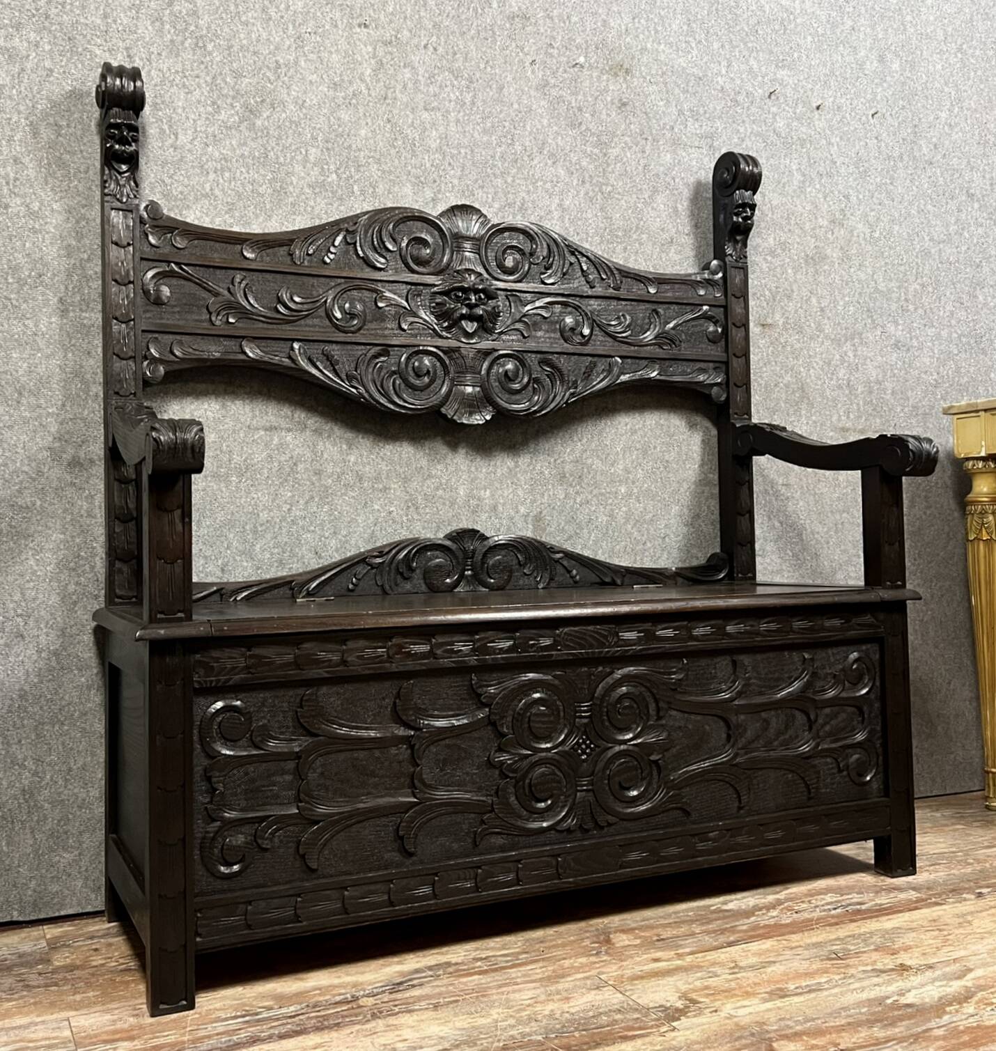 Italian Renaissance style solid wood chest bench decorated with grimacing masks