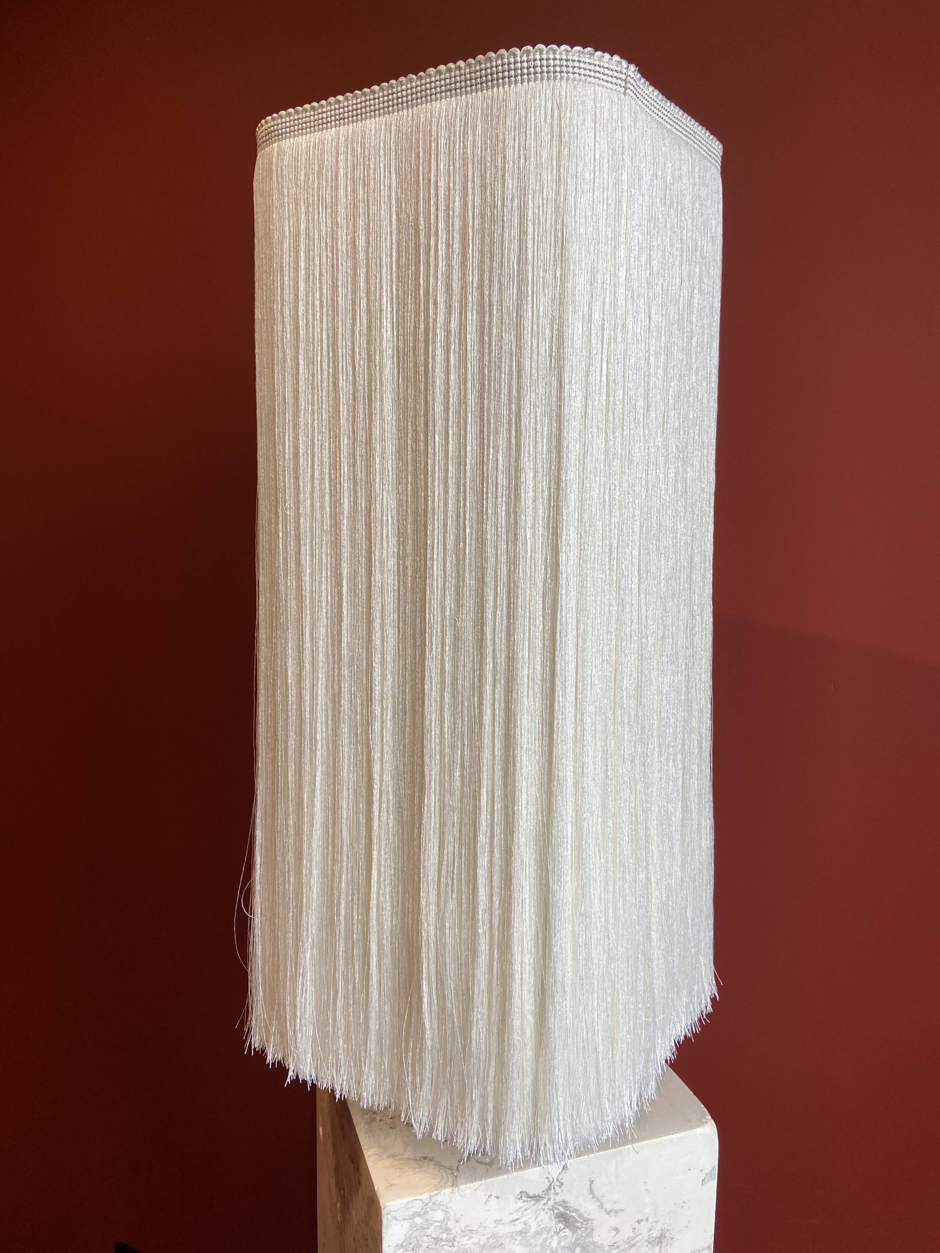 Beige marble stucco base, Houles white ecru fringed lampshade.