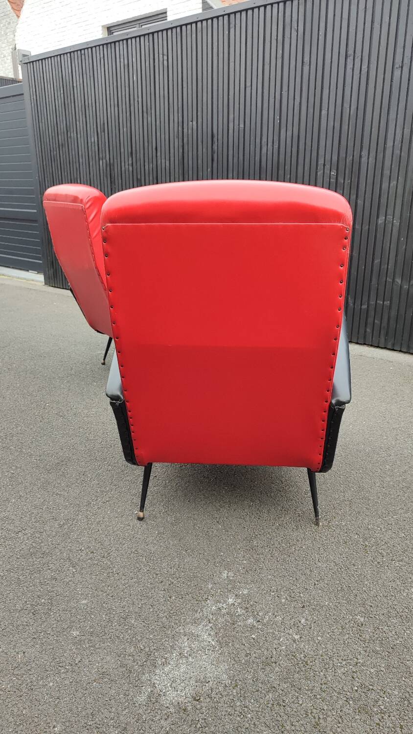 Pair of red and black faux leather armchairs