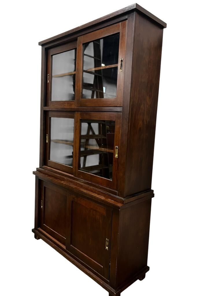 Vintage wooden display cabinet with sliding doors.
