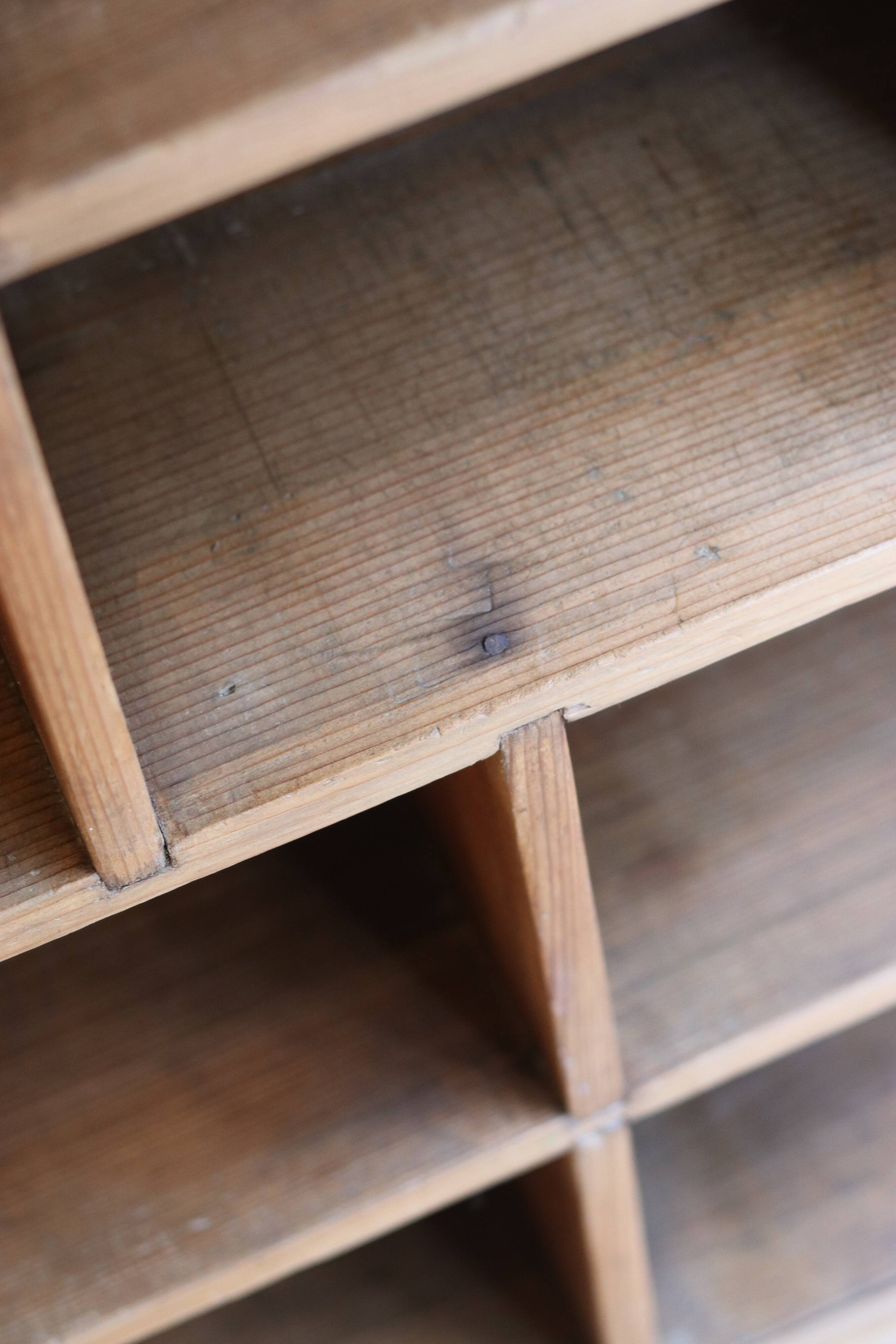 Large storage unit with compartments in waxed pine, early 20th century.
