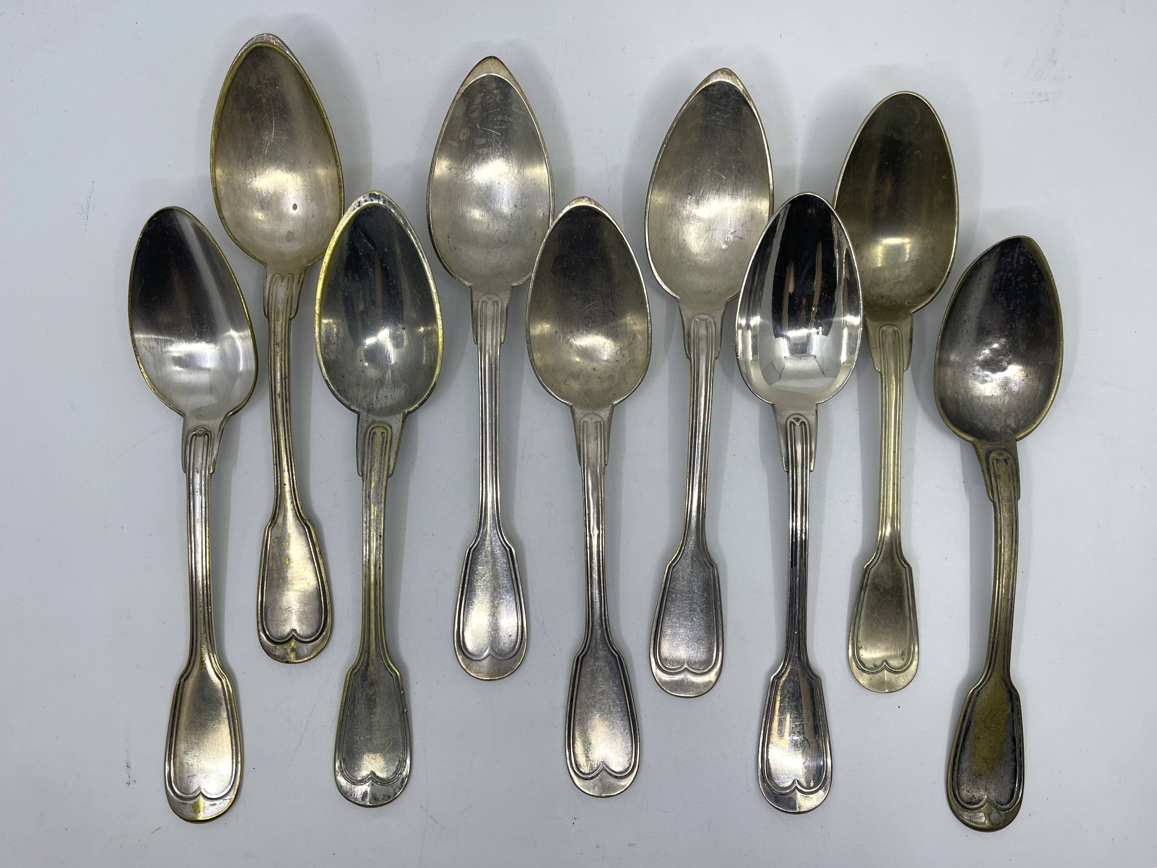 Set of 9 silver-plated soup spoons with a bi-lobed filet pattern.