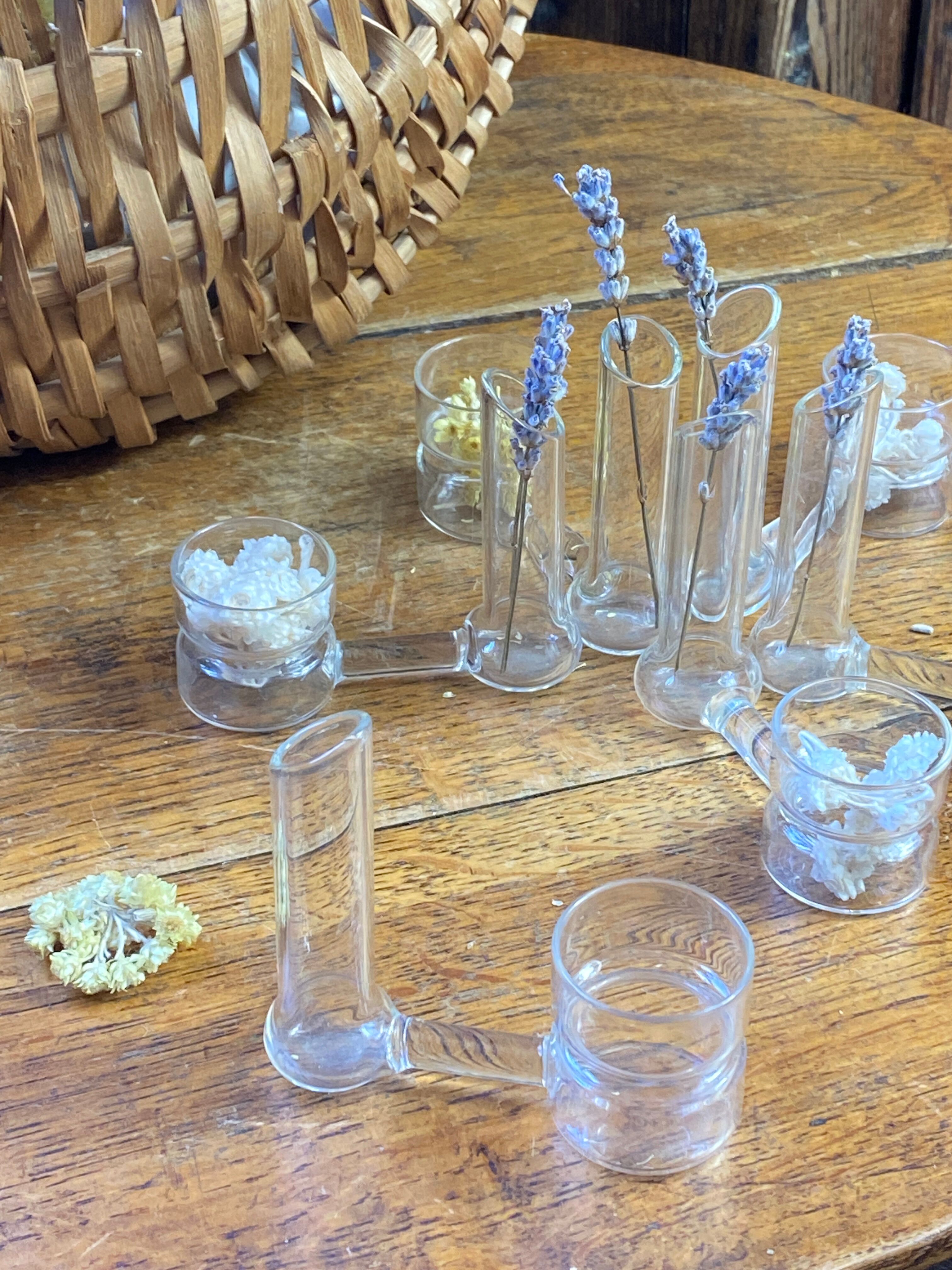 Knife rests, flower vases and candle holders in blown glass.