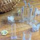 Knife rests, flower vases and candle holders in blown glass.