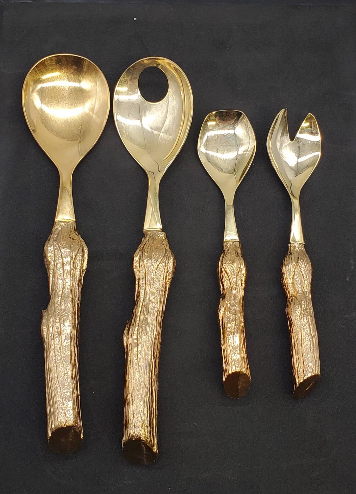 Lot of serving spoons, dessert spoon and fork in gold metal.