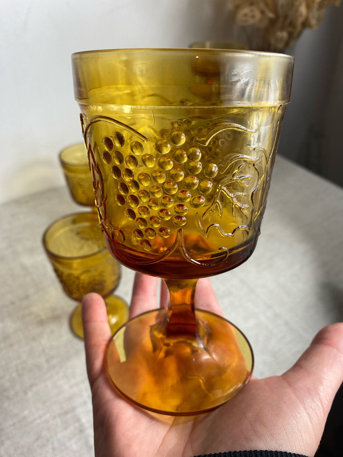 Six stemmed glasses in amber-colored molded glass