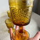 Six stemmed glasses in amber-colored molded glass