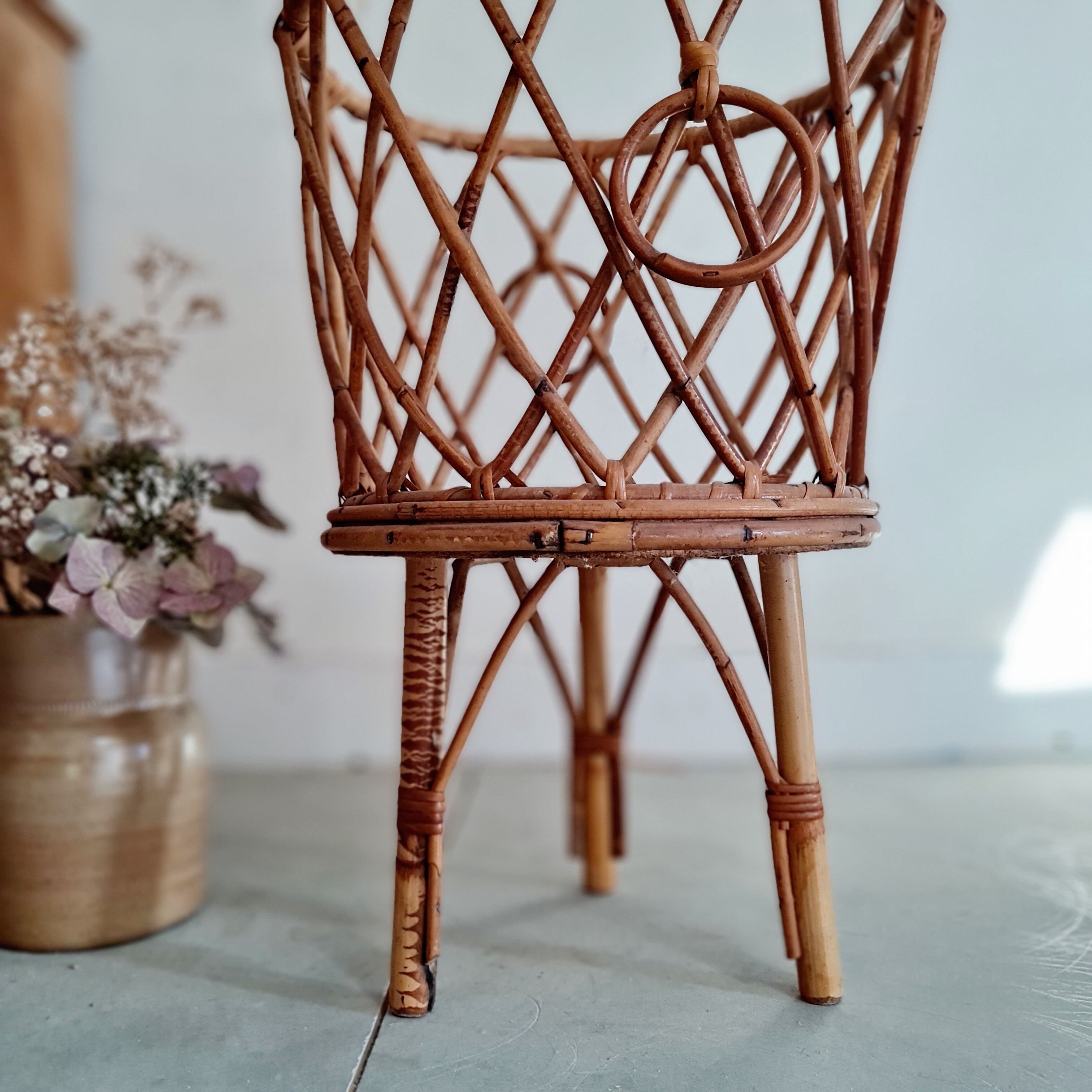 Old tripod rattan plant holder