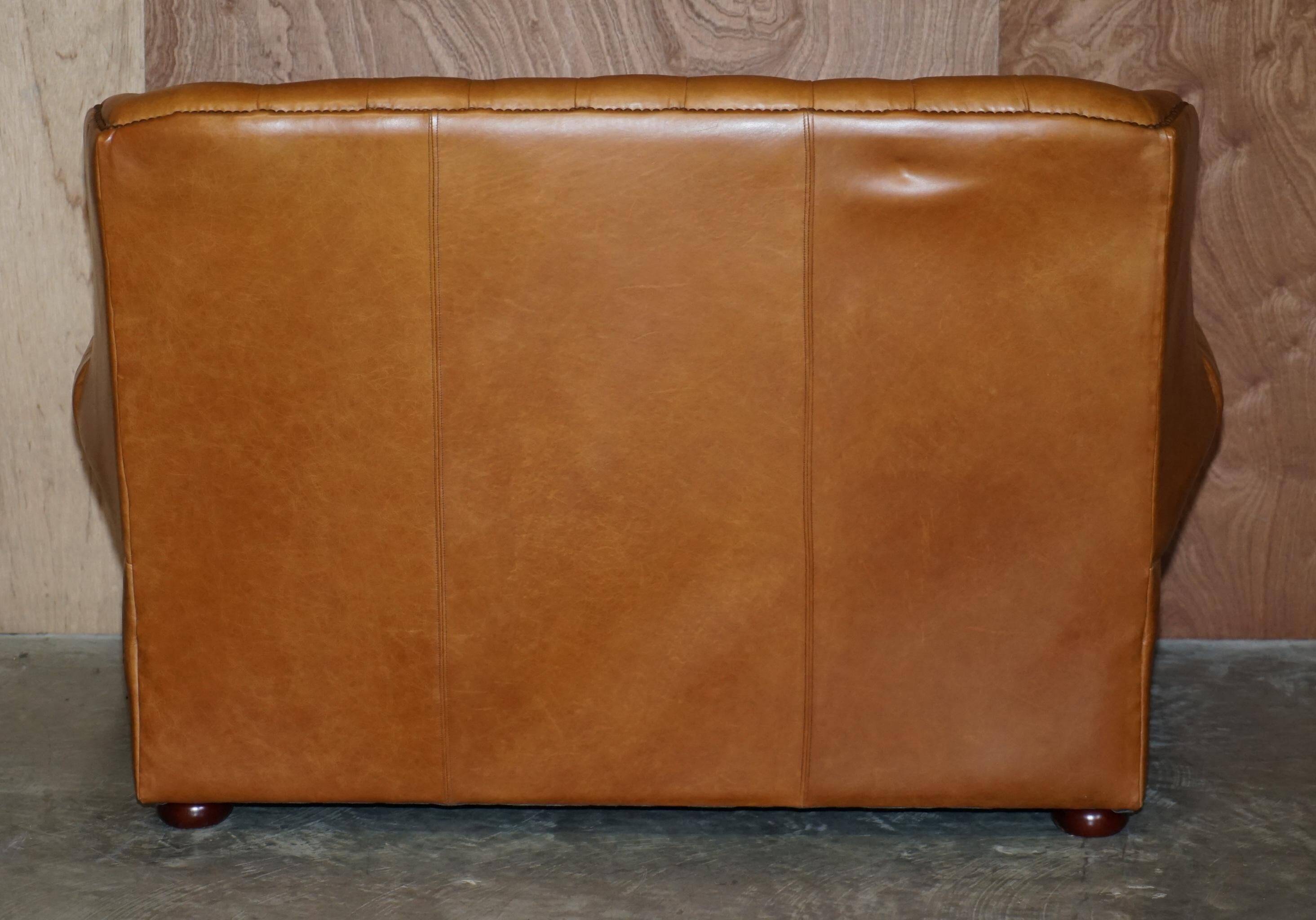 Small Chesterfield leather sofa with a high back.