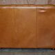 Small Chesterfield leather sofa with a high back.