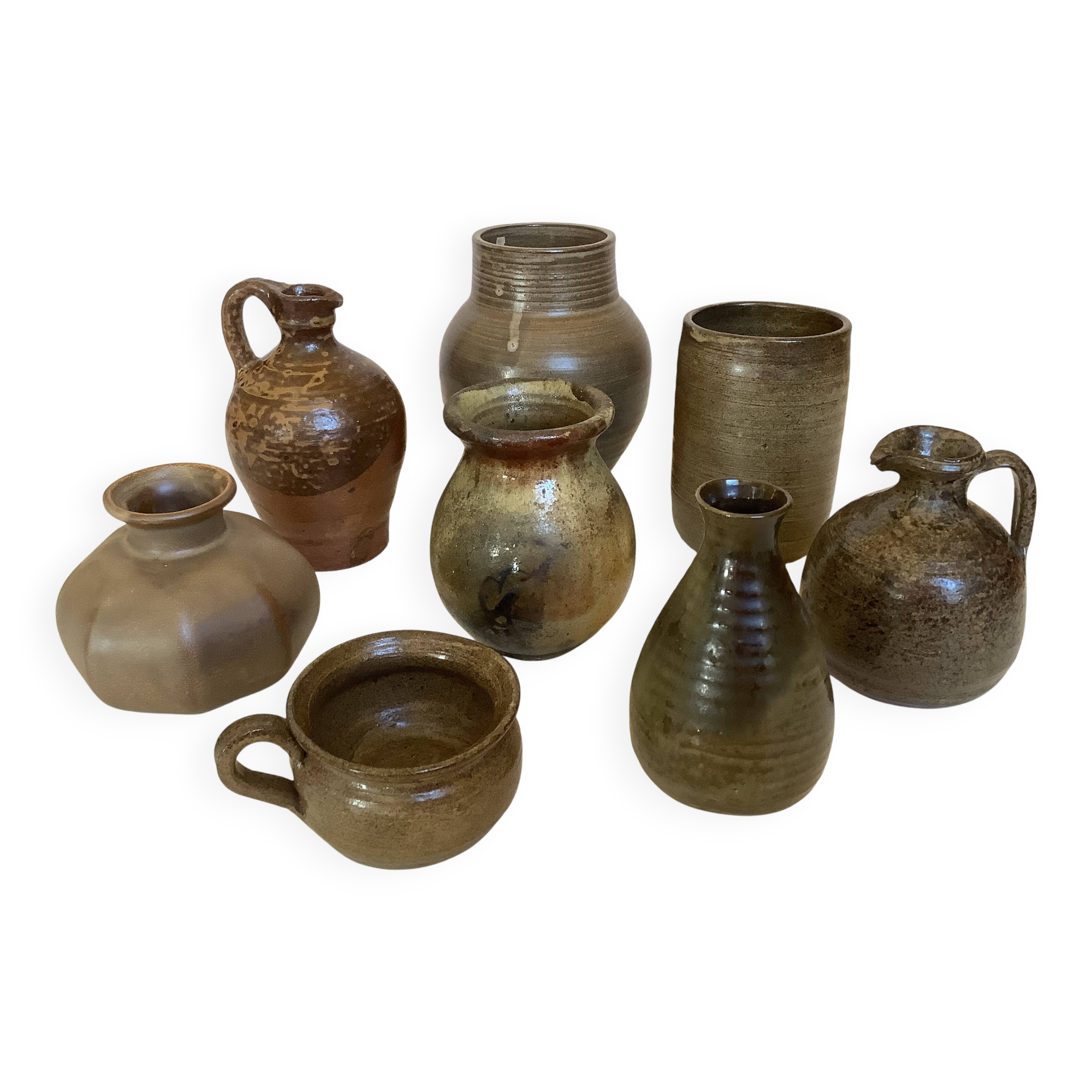 Eight brown ceramic pitcher vases