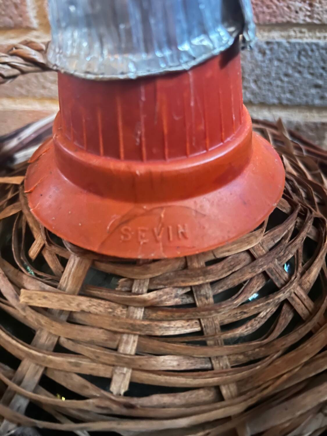 Old glass demijohn with wicker basket.