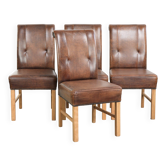 Ensemble de 4 grandes chaises de salle à manger en peau de mouton dans une couleur cognac foncé.