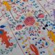 White suzani kilim rug with embroidered colorful patterns