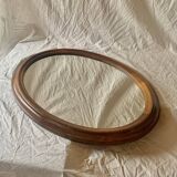 Old large oval wooden wall mirror