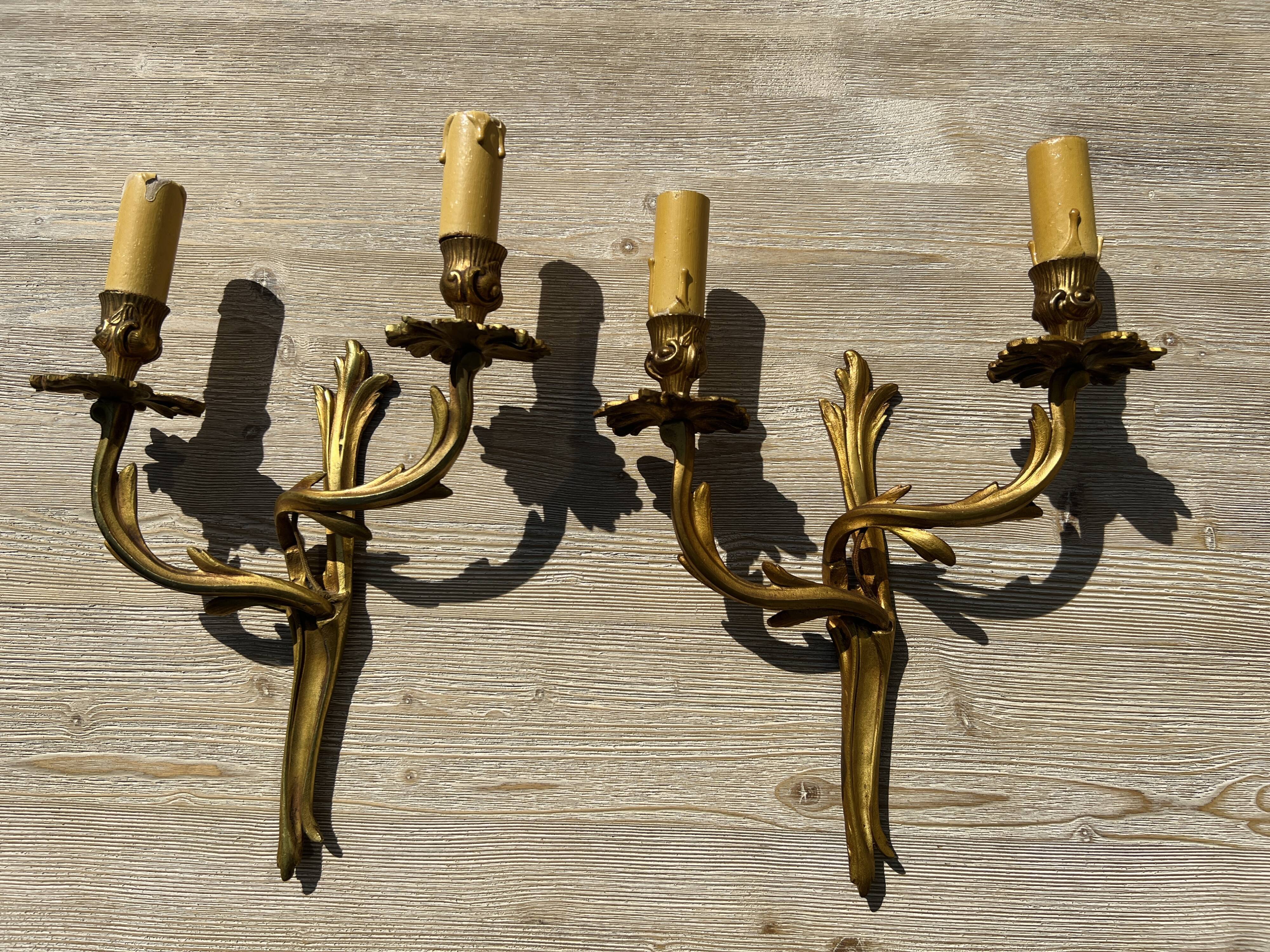 Pair of Louis XV wall lamps in gilded bronze
