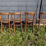 Set of four wooden bistro chairs, green seat, mid-20th century.