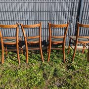 Set of four wooden bistro chairs, green seat, mid-20th century.