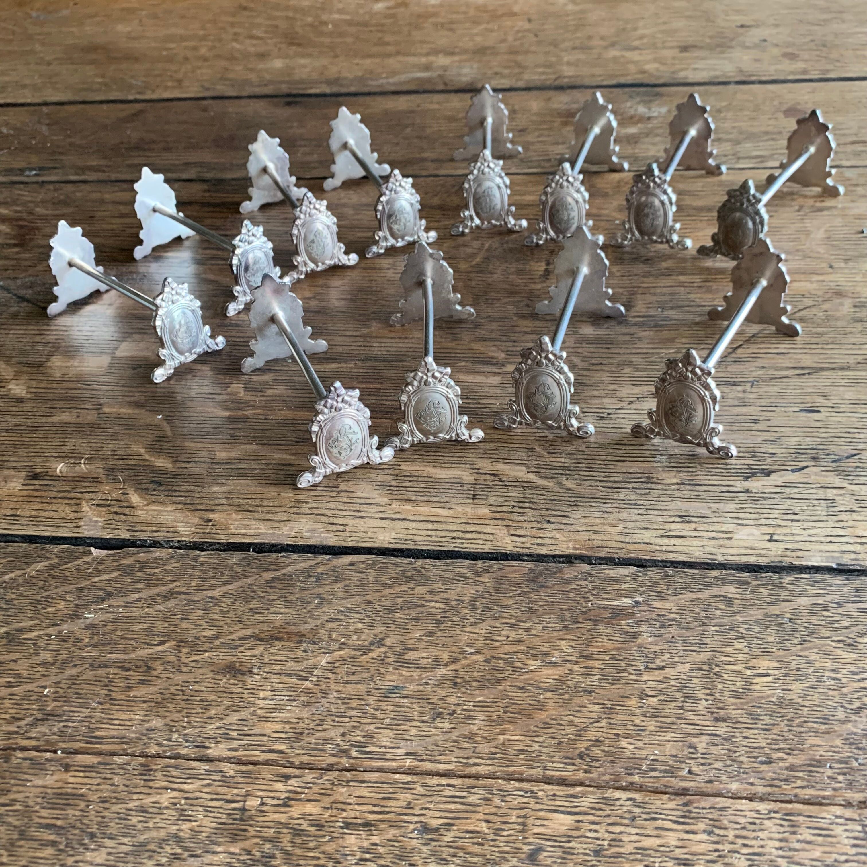 Series of 12 monogrammed silver metal knife holders